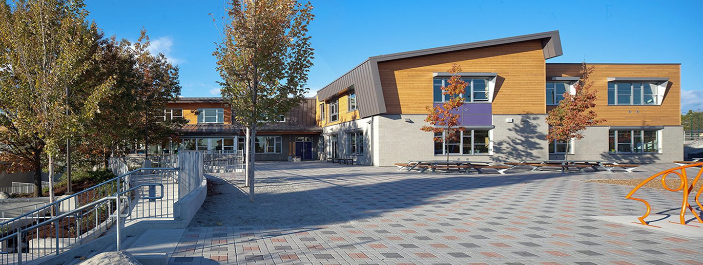 A building surrounded by a brick walkway and benches for seating.
